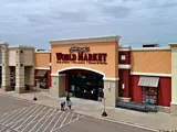 Exterior aerial view of World Market building and parking area apart of Central Texas Marketplace