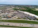 Exterior aerial view of parking area and multiple businesses within Central Texas Marketplace